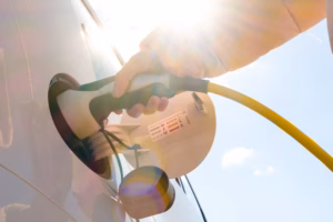 a person filling a car with a gas pump